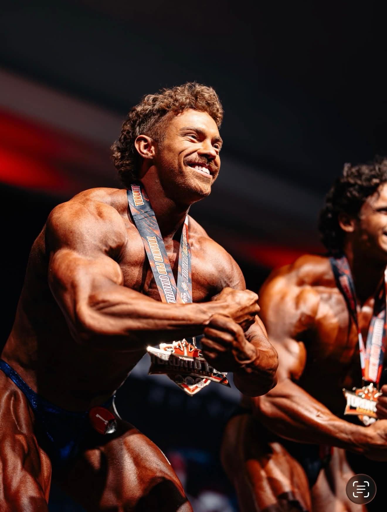 Boston Blore celebrating with his medal on stage